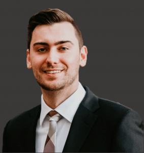 headshot of young man in a suit and tie