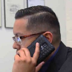 man on phone in office conducting business over the phone