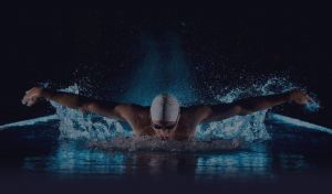 man swimming in competition